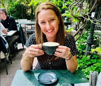 Lady enjoying a cup of coffee outdoors